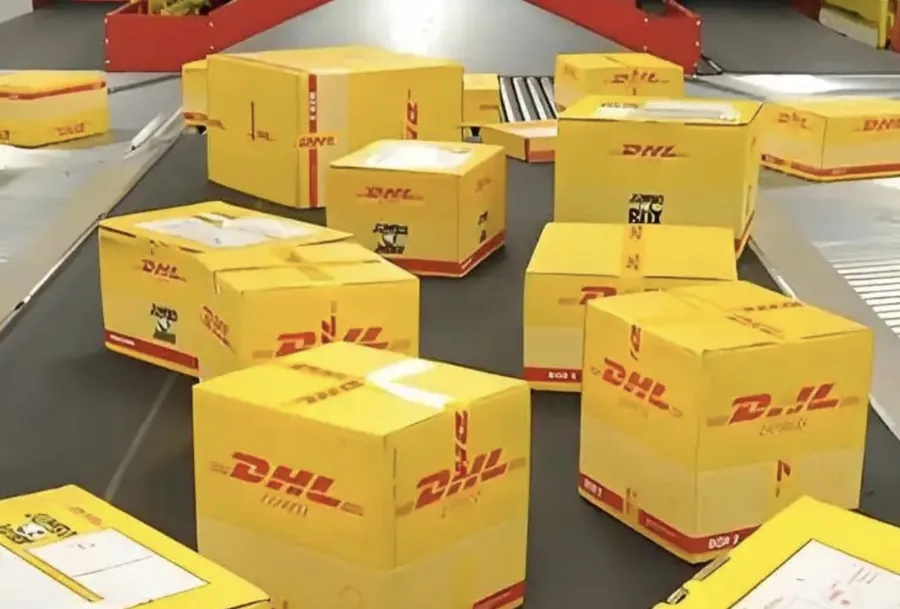 DHL Express packages on the Guangzhou conveyor sorting belt — daily rep bag dispatch batch to US, UK, EU