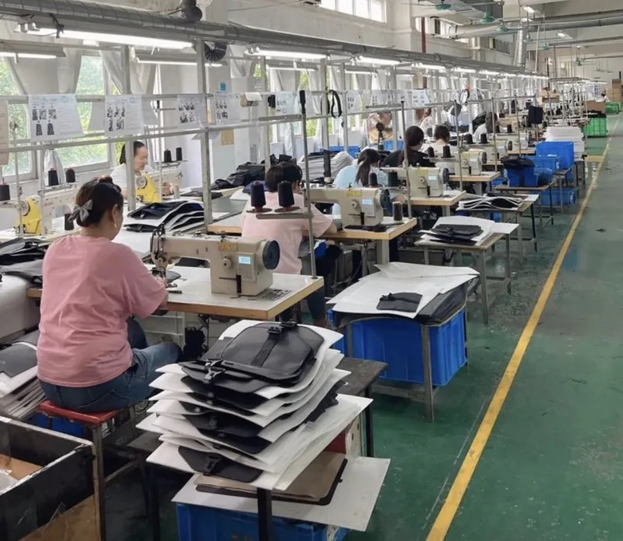 Bag production floor at our Guangzhou sourcing partner in Baiyun District — sewing lines mid-batch